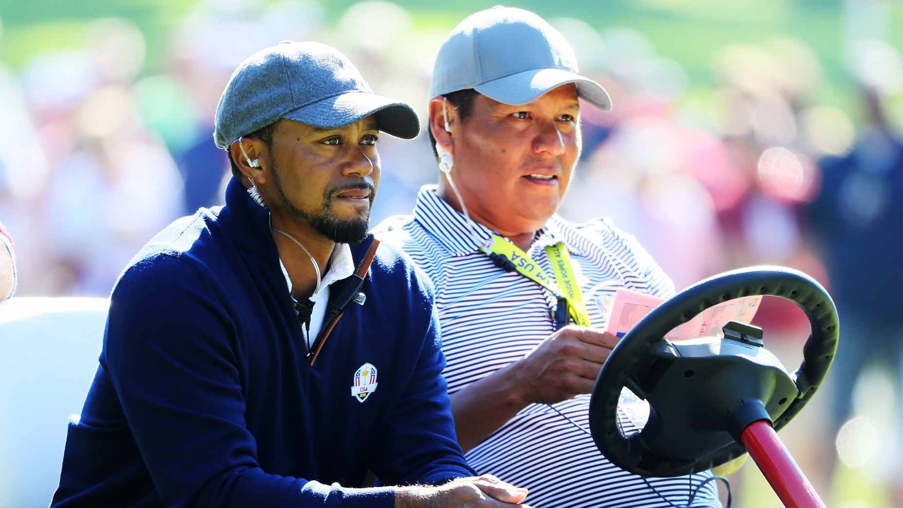 Tiger Woods and Notah Begay III look on during afternoon fourball matches of the 2016 Ryder Cup at Hazeltine National Golf Club.