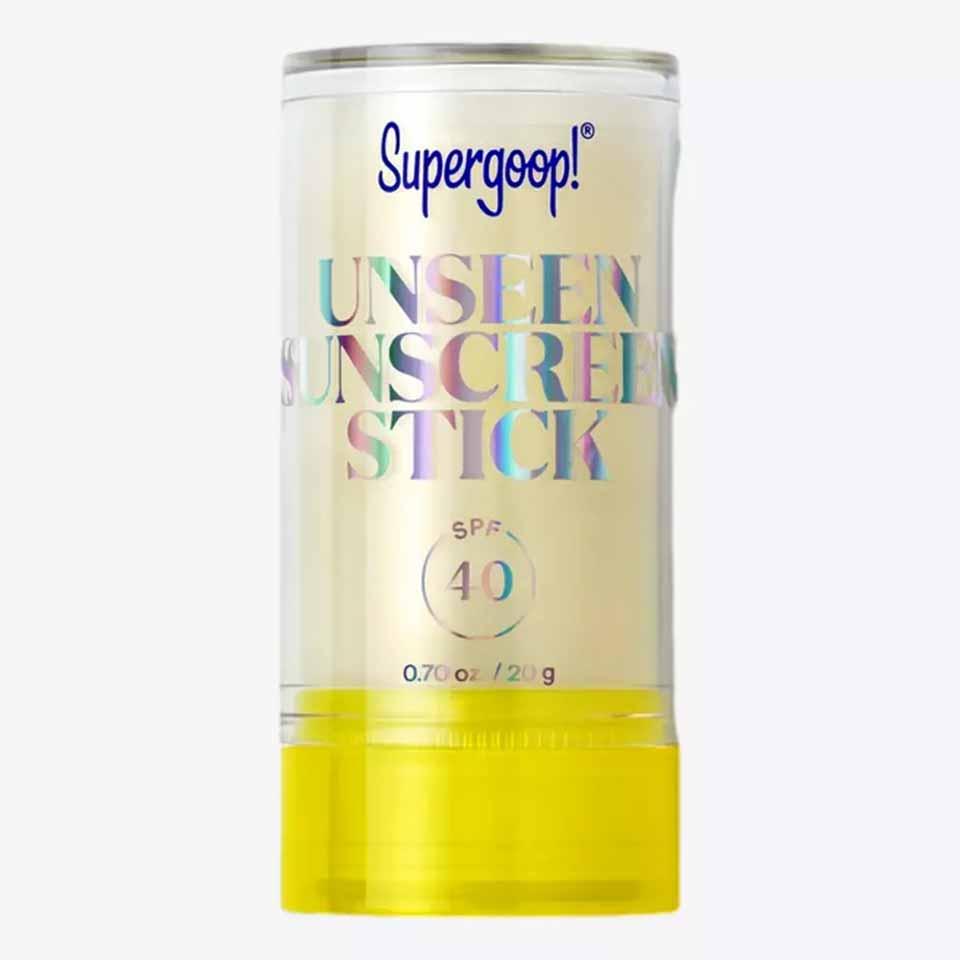 A clear stick of Supergoop! Unseen Sunscreen with SPF 40, featuring iridescent lettering on a transparent container and a bright yellow twist-up base&mdash;perfect as one of your thoughtful Father&rsquo;s Day gifts.