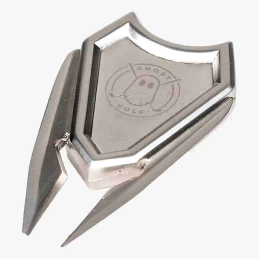 A metal divot tool with a shield-shaped top engraved with a ghost logo and the words GHOST GOLF; the sleek, silver design makes it a great accessory to pair with the best golf bags 2026 has to offer.