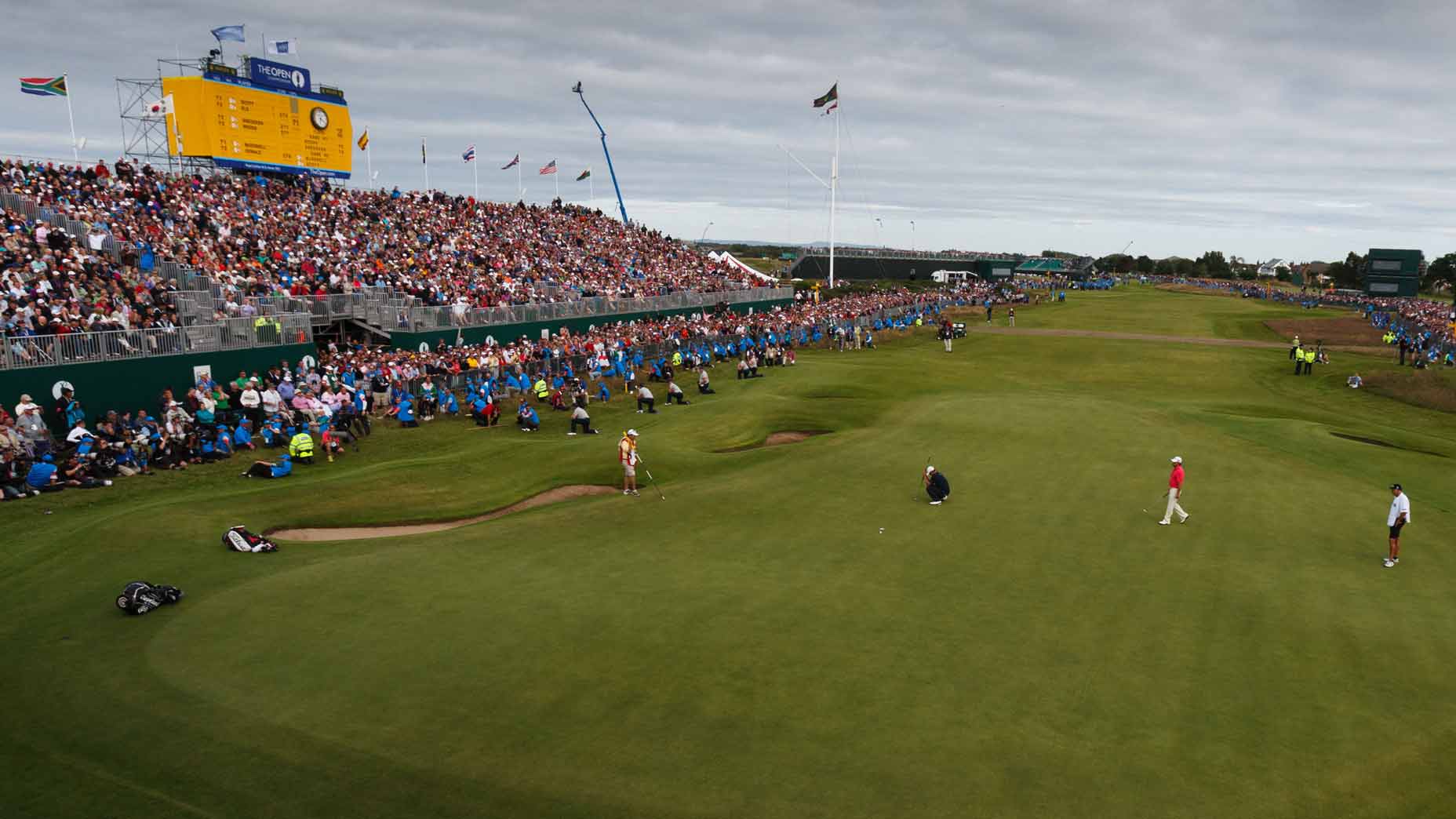 Royal Lytham & St. Annes' 18th hole seen during 2012 Open Championship, with Adam Scott crouched on green.