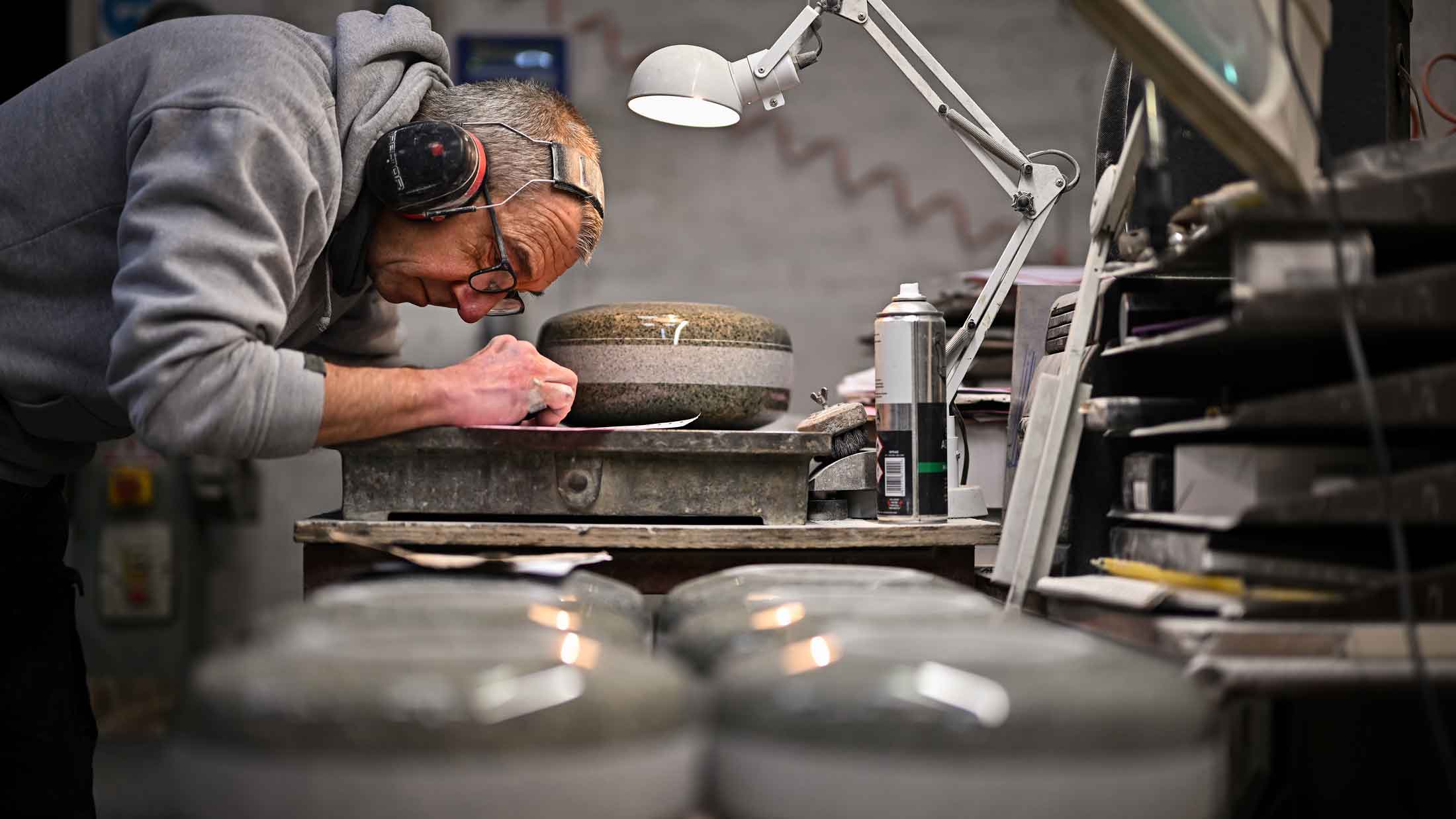 ohn Brown works on a piece of granite rock being made into a curling stone at Kays Curling