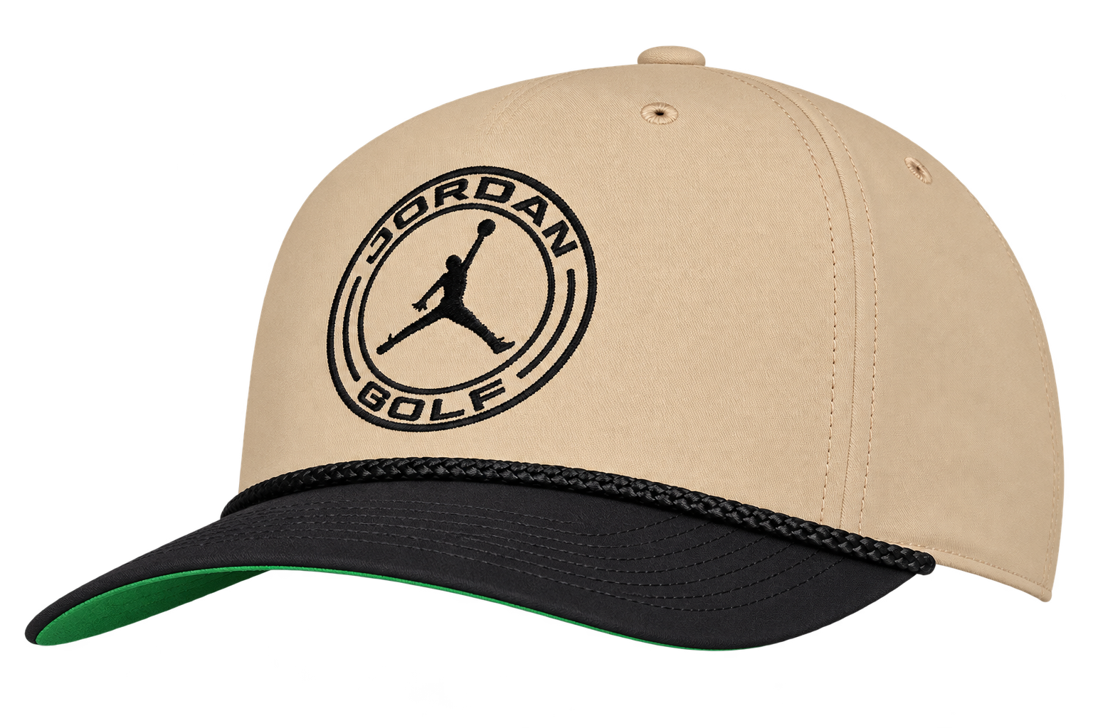 Tan and black baseball cap with a round Jordan Golf logo featuring a Jumpman silhouette. Perfect for fans of stylish golf hats, this cap also features a green underside on the brim and a decorative black rope above the visor.
