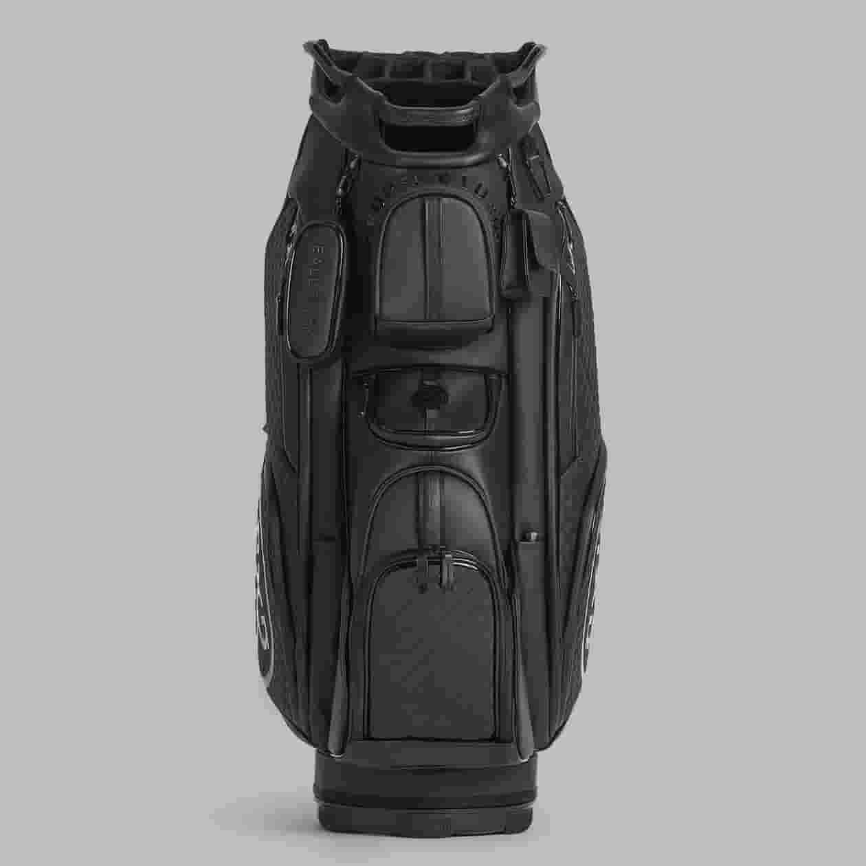 A black golf bag with multiple zippered pockets and compartments, viewed from the front against a plain gray background. The bag features sturdy handles and a sleek, modern design&mdash;an excellent pick among the best golf bags 2026.