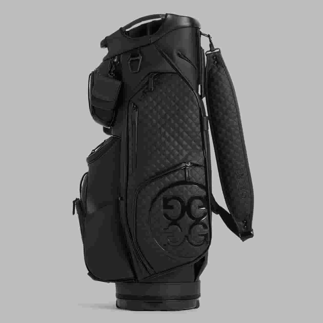 A black golf bag with a quilted pattern, multiple zippered pockets, a padded shoulder strap, and GG logo detailing&mdash;an elegant choice for those seeking the best golf bags 2026&mdash;displayed against a plain grey background.