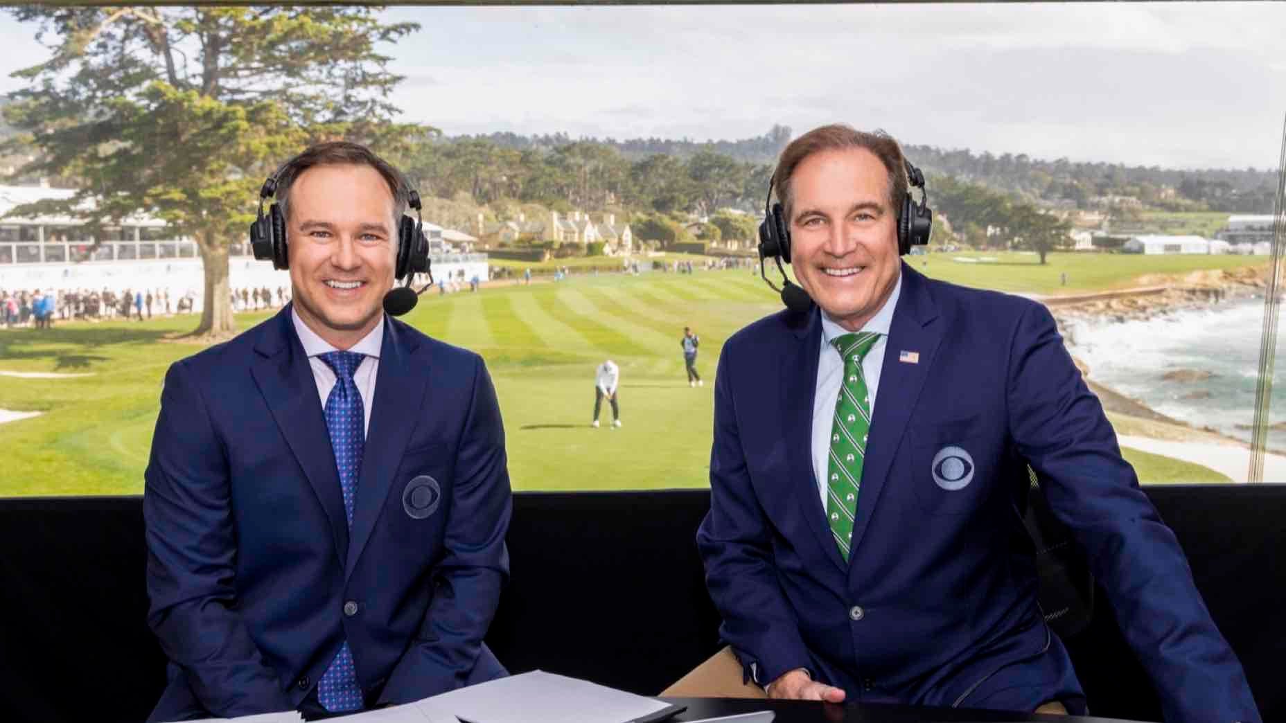 Two male sports commentators in suits, headsets on, sit at a broadcast desk with papers. Behind them, Trevor Immelman lines up a putt on the green, watched by spectators&mdash;with an air of neurotic readiness in the tense atmosphere.