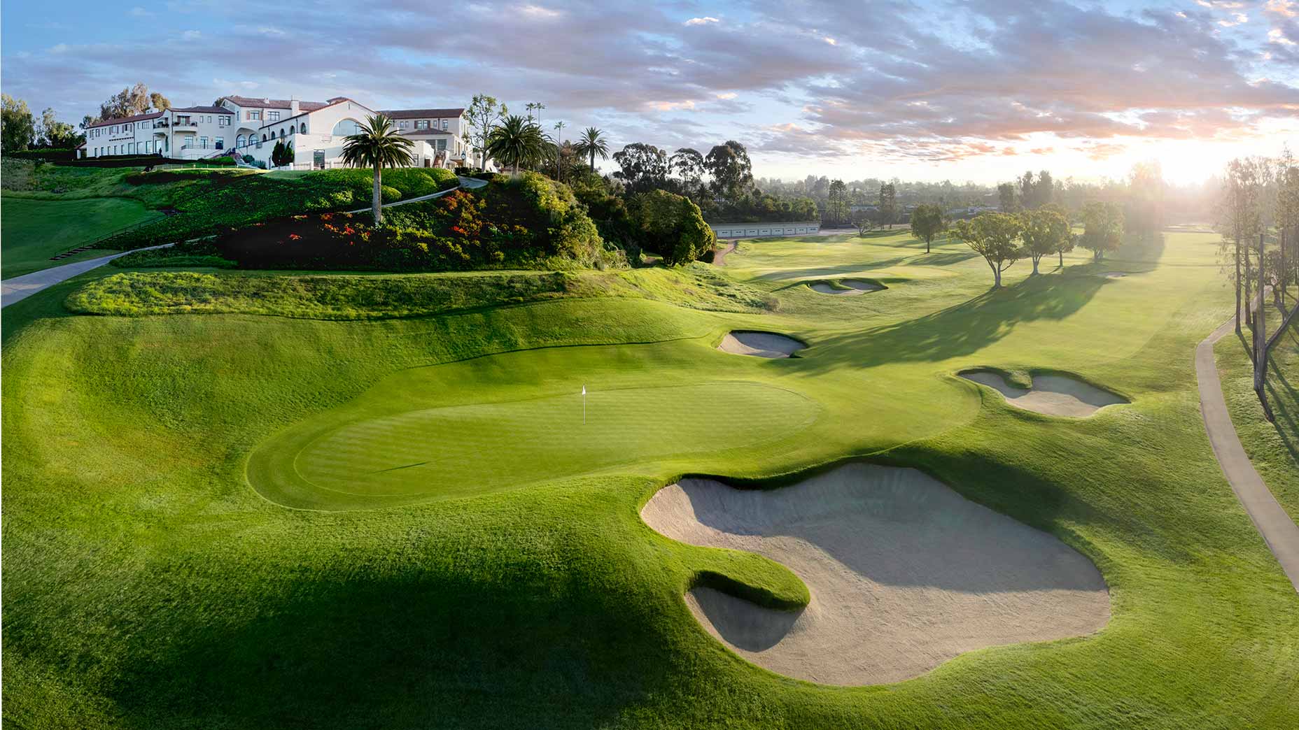 A scenic golf course at sunrise, with smooth green fairways and sand bunkers, evokes the prestige of the U.S. Women's Open&mdash;its large white clubhouse on a hill hinting at Riviera&rsquo;s deeper meaning for golf enthusiasts.