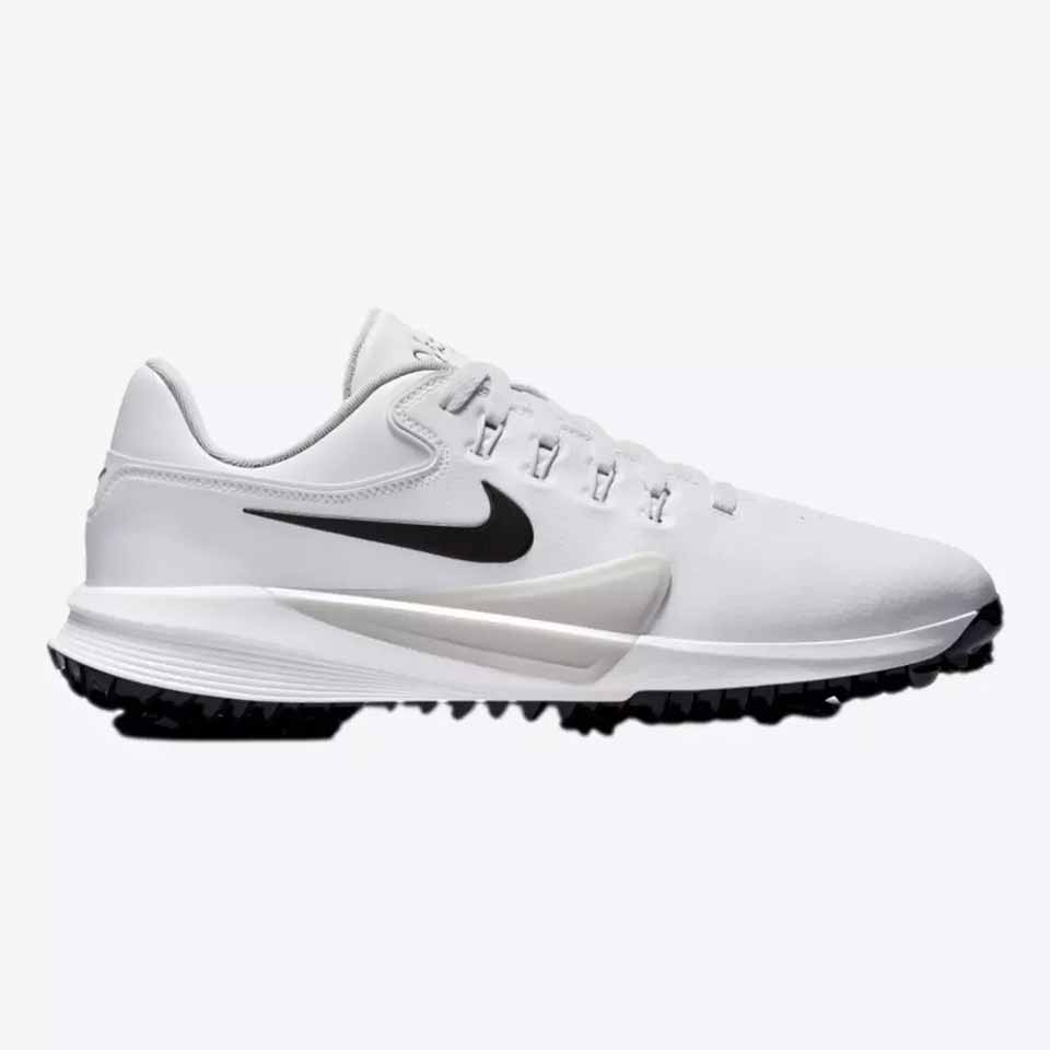White athletic shoe with a black Nike swoosh logo, black sole, and spiked tread. The shoe design appears sleek, with a low profile and lightweight construction&mdash;just like Nike golf shoes worn by Scottie Scheffler&mdash;perfectly suited to support a powerful swing during sports or outdoor activities.