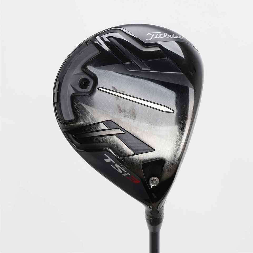 A close-up of a Titleist TSi3 golf driver head, showcasing its black and silver design, branding, and aerodynamic details&mdash;trusted by top 10 players on tour&mdash;on a plain white background.