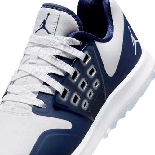 Close-up of a white and navy blue athletic sneaker featuring the Jumpman logo, white laces, and a modern, ventilated side panel design&mdash;perfect for those seeking the best Jordan golf shoes style and performance.