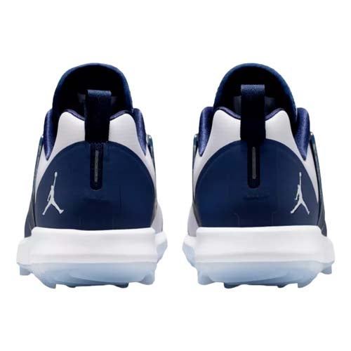 Back view of a pair of navy blue and white athletic shoes with the Jordan Jumpman logo on the heel&mdash;these could be among the best Jordan golf shoes, featuring white midsoles and dark blue accents on the upper and heel tab.