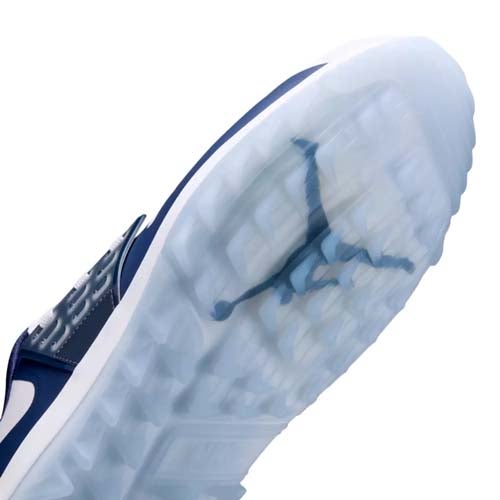 Close-up view of the translucent sole of a sneaker, featuring the Jumpman logo seen through the icy, textured rubber outsole&mdash;showcasing why this model ranks among the best Jordan golf shoes. The shoe is primarily navy and white.
