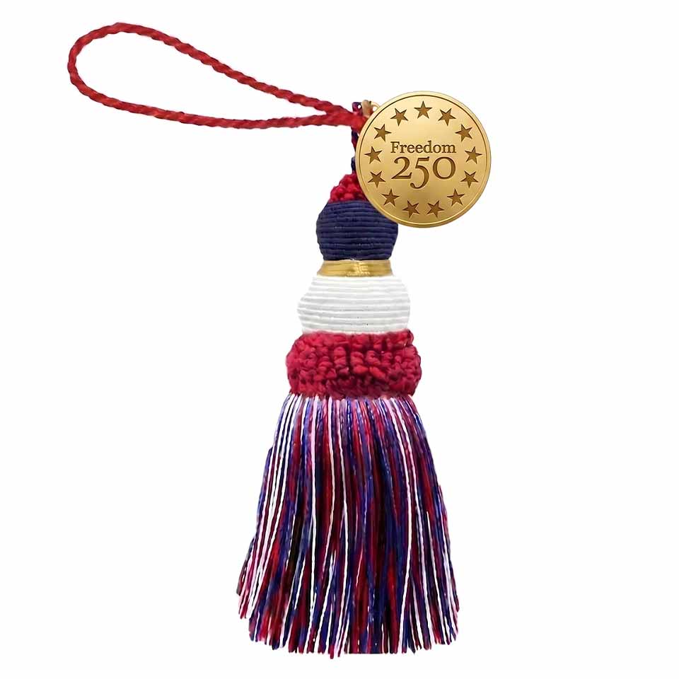 A red, white, and blue tassel ornament with a braided red loop and a gold disc tag that reads Freedom 250 surrounded by stars&mdash;perfect to celebrate America and honor America's 250th birthday.