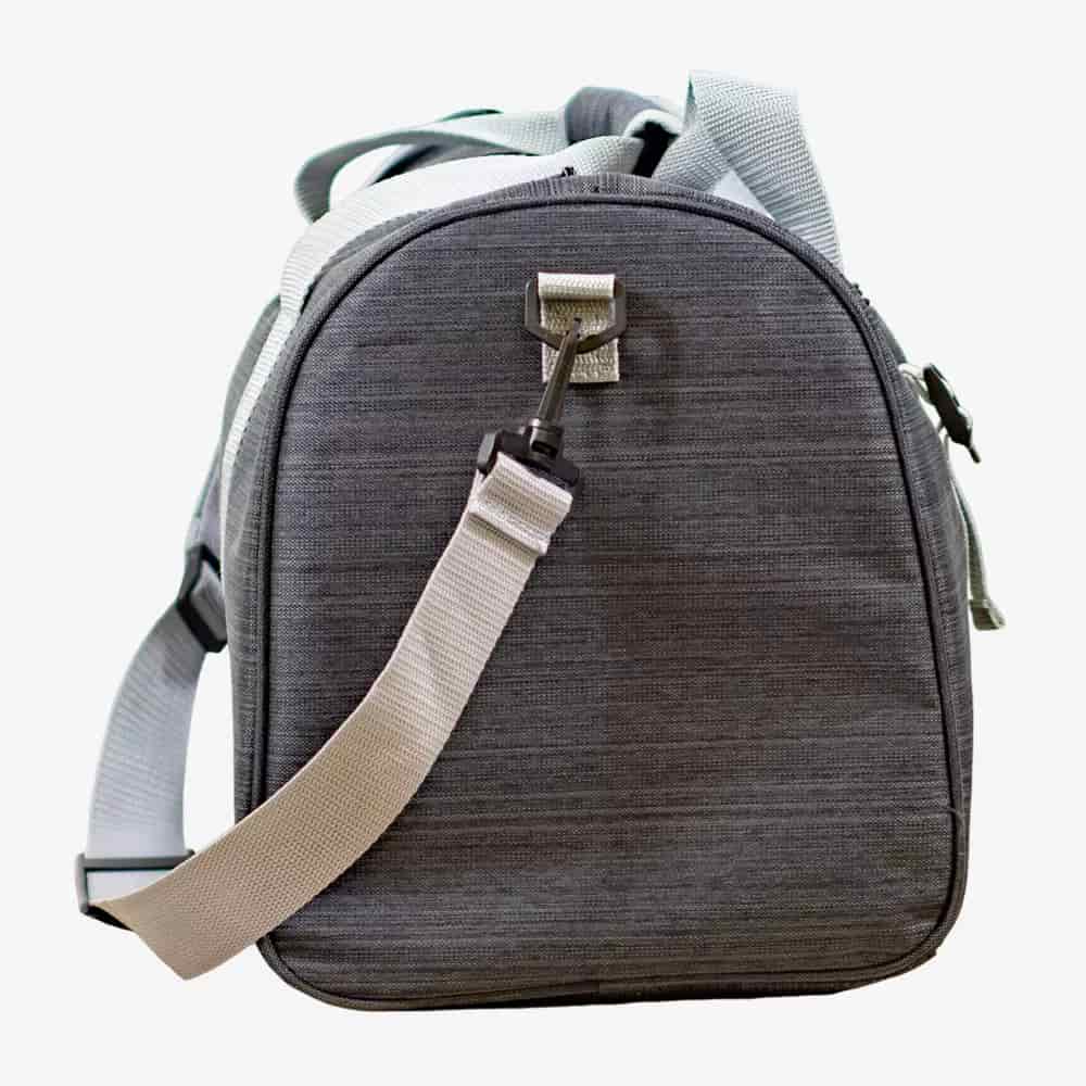 A gray fabric shoulder bag with a rounded top, light gray adjustable straps, and a metal buckle&mdash;perfect for carrying the best golf rangefinders&mdash;shown standing upright against a plain white background.
