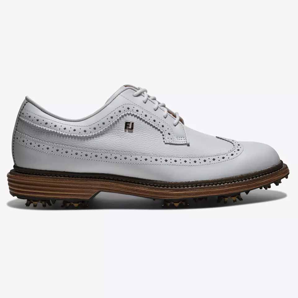A white leather FootJoy golf shoe with brogue detailing, brown sole with spikes, lace-up design, and an FJ logo on the side&mdash;polished golf shoes like these are favored by players such as Michael Brennan. Viewed from the left.