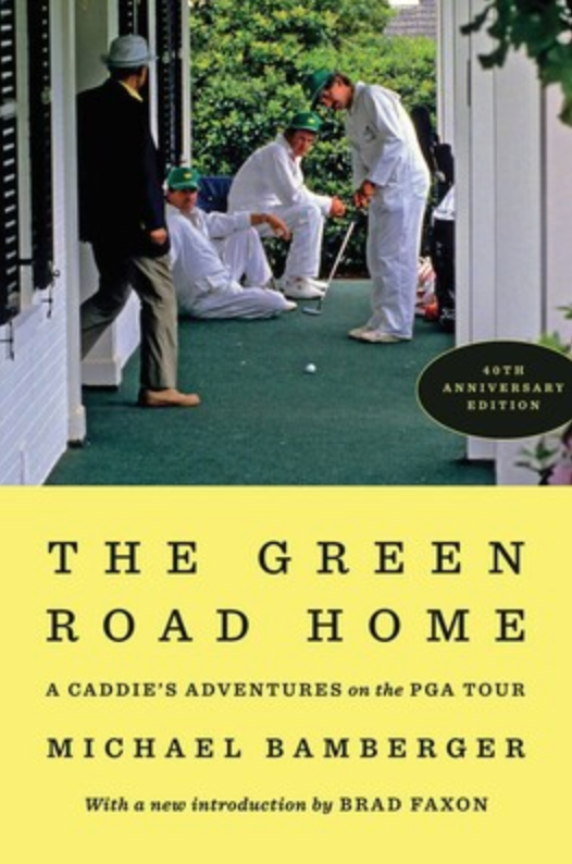 Four men, one putting, stand on a golf green by a white building&mdash;an evocative scene for any fan of golf travel. The book cover reads, The Green Road Home by Michael Bamberger, with a 40th Anniversary Edition badge, inviting readers to journey through memorable golf destinations and experiences.