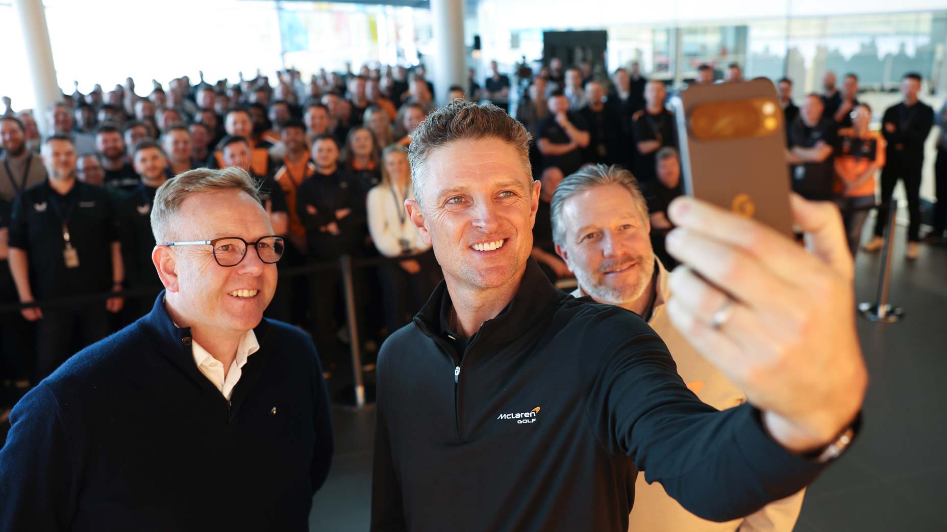 Nick Collins, Justin Rose and Zak Brown at a McLaren employee event.