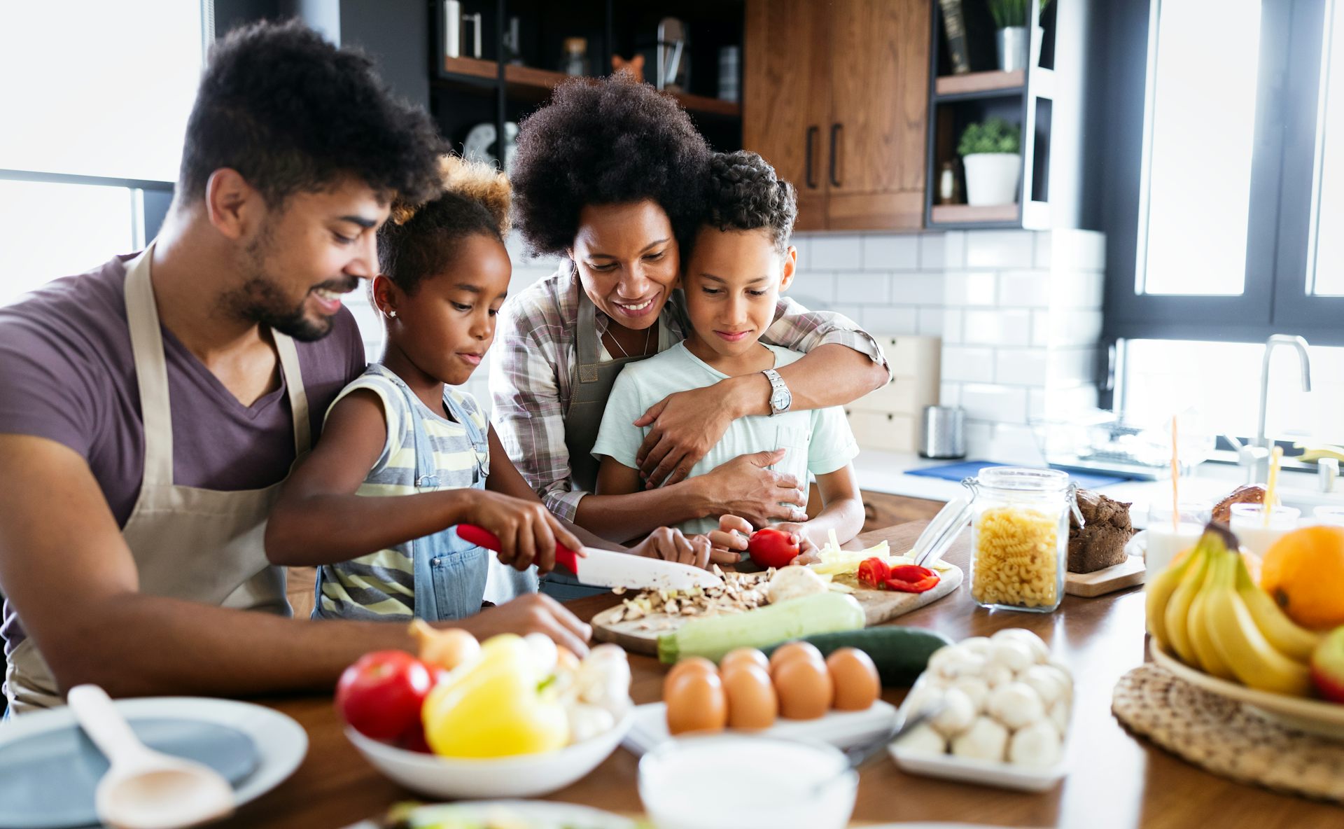 A young family cooking together in the kitchen.