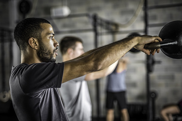 Two Men Do Kettlebell Swings | Does Cardio Kill Gains